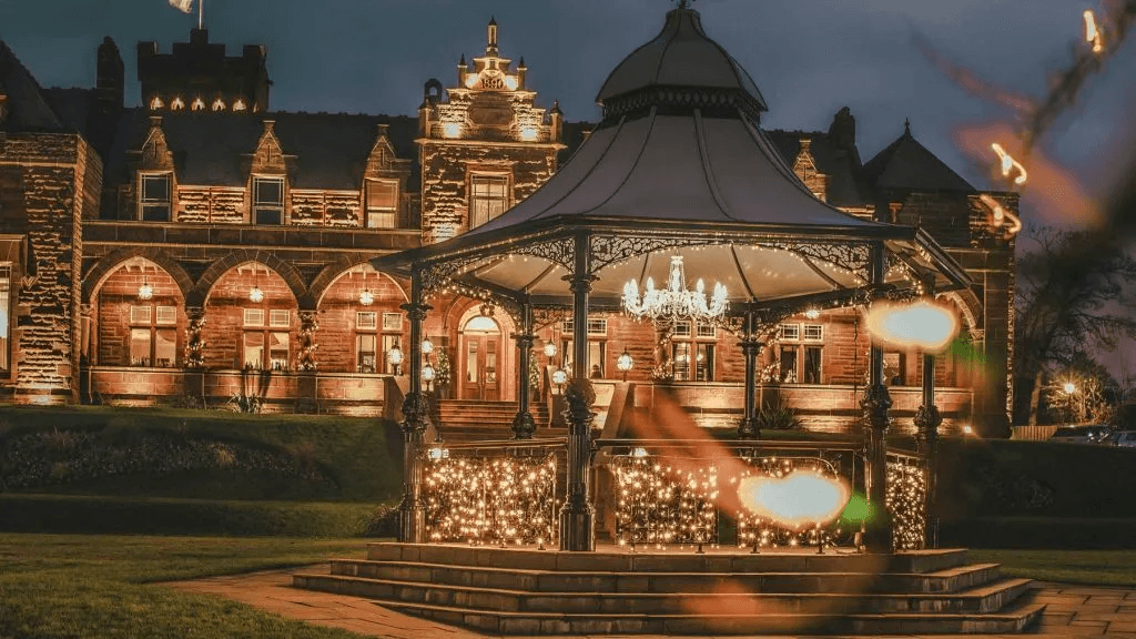 Illuminated luxury manor house and garden gazebo at night, ideal for wedding venues near Glasgow